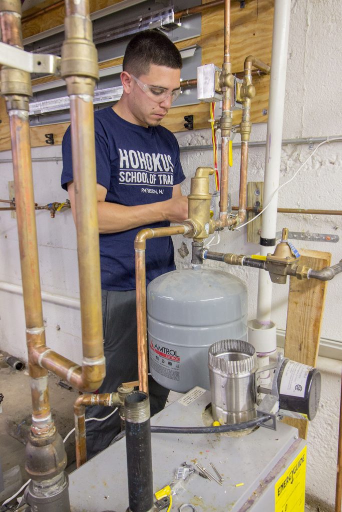 Plumbing apprenticeship student practices piping