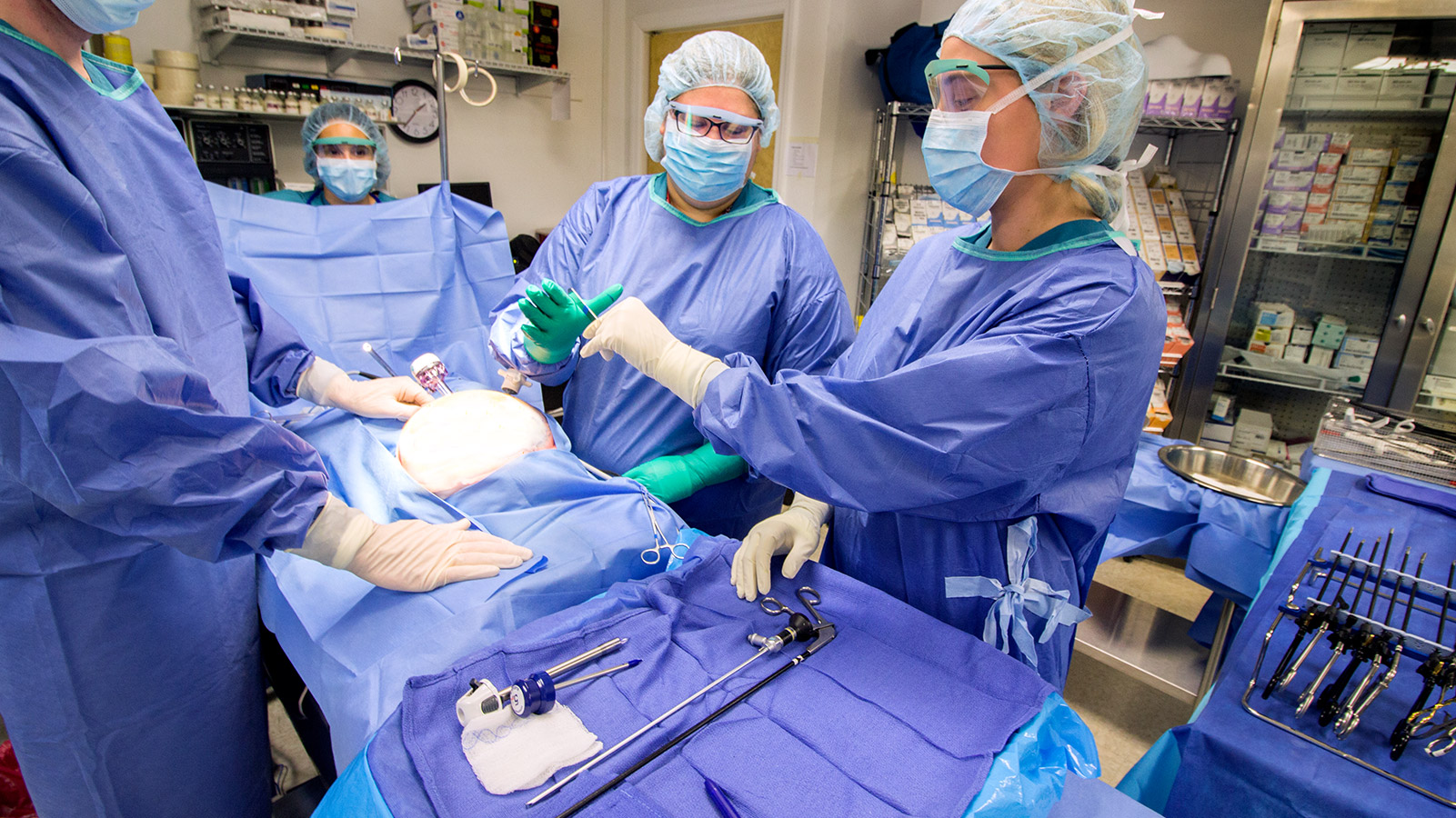 Surgical Technician students practice performing surgery together in mock operation room