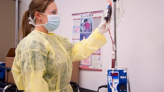 registered nurse student practices using a blood bag device