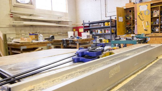 construction technology class filled with tools and a mechanical saw in the foreground
